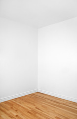 Empty corner of a room with wooden floor