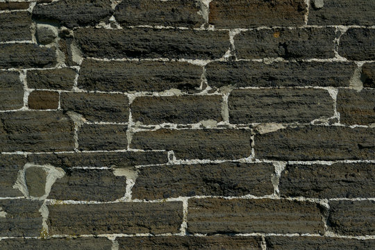 Weathered stained old brick wall