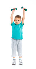 Sporty little boy with dumbbells.