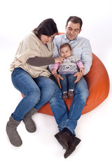 Happy family of parents and daughter in causal clothes