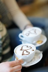 Young romantic couple sitting on sofa in front of fireplace at h