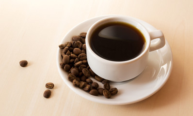 white cup and coffee beans