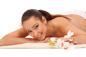 Obraz na płótnie Canvas A beautiful smiling woman is lying on a towel