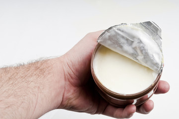 Open cream box holding on the human hand