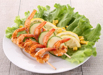 grilled shrimp on stick with salad