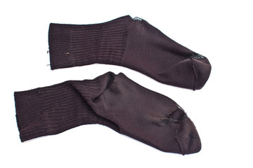 Two worn black socks on the white
