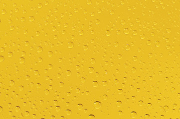 Many water drops on the yellow background