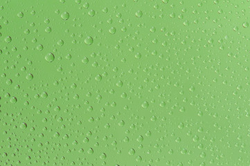 Many water drops on the green background