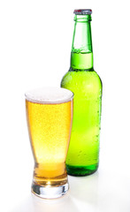Beer in a green bottle and glass on a white background