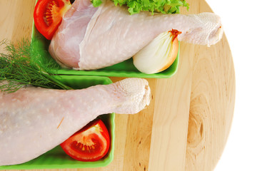 raw leg of hen on wood