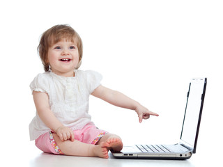 Funny baby using a laptop over white background