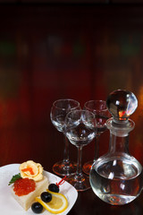 three glasses of vodka and a bottle