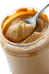 an open jar of peanut butter with spoon