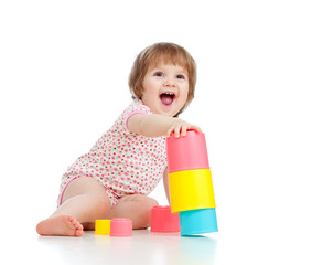 Funny little child playing with cup toys, isolated over white