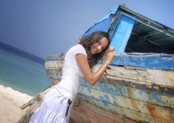 Sensual sexy female model in white clothes nearby a ship wreck