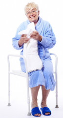 elderly woman sitting on a shower seat, medical supply