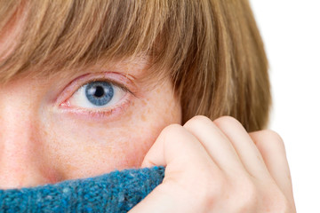Blue eye closeup shot. Winter portrait of a young woman