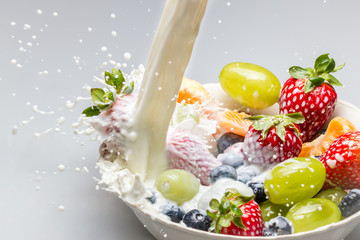 Fresh fruit with milk poured as a symbol of healthy breakfast