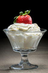 Starwberry with whipped Cream in glass bowl