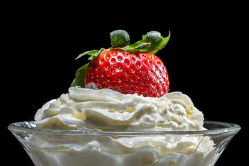 Closeup starwberry with whipped Cream in glass bowl