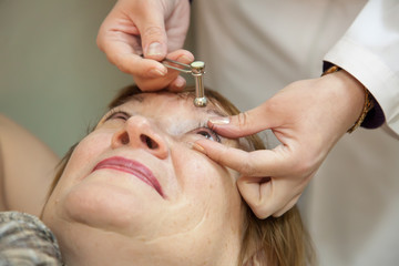 Ophthalmologist measures the  ocular tension