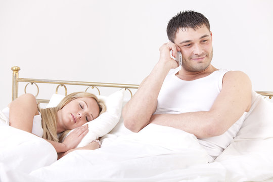 man cheating while woman sleeping