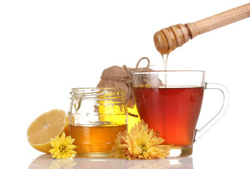 honey, lemon and a cup of tea isolated on white