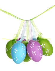 Colorful easter eggs hanging on ribbons isolated on white