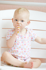 sitting toddler eating an apple