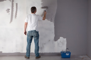 Man painting a wall.