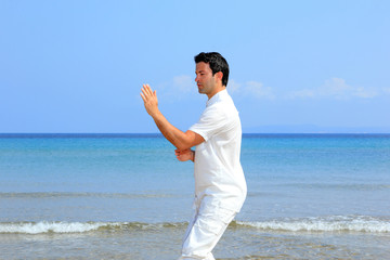 man on the beach meditating