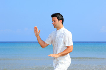 Fototapeta na wymiar man on the beach meditating