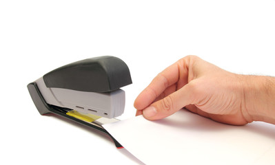 hand sheets and stapler over white
