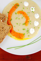 soup with bread and pepper over wooden table
