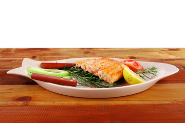 roast salmon on plate over wood