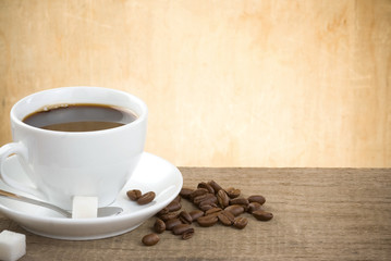 cup of coffee and beans on wood