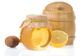 jar of honey and lemon isolated on white