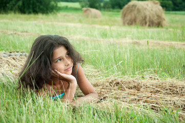 Beautiful long-haired girl in a field © olgavolodina