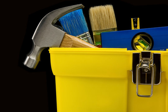 tools in construction toolbox on black