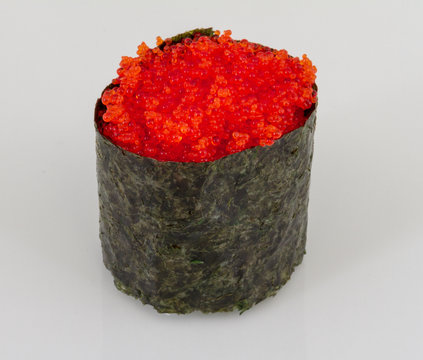 Sushi with fying fish caviar isolated over white background