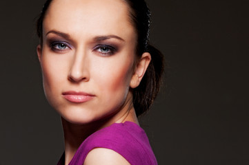 studio portrait of beautiful woman over dark