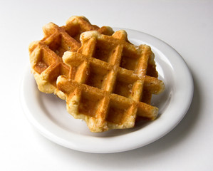 Sweet waffles on plate on white background