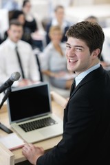Young  business man giving a presentation on conference