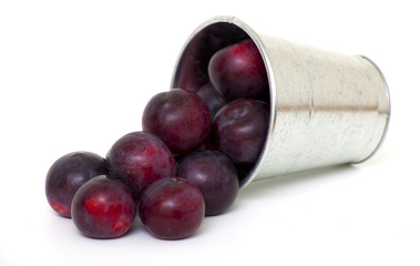 bucket with falling plums