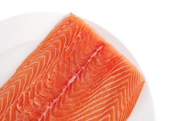 big salmon fillet on white plate