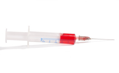 Fototapeta premium syringe with red medication on white