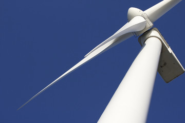 A wind-turbine against a clear blue sky