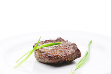 meat food : roasted fillet mignon on white plate with chives