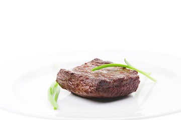 meat food : roasted fillet mignon on white plate with chives
