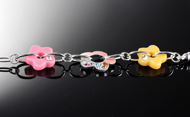 Beautiful silver bracelet with bright flowetrs